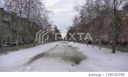March 22 2026 Barnaul Russia alley on Leninsky Avenue from October Square covered in snow cold early spring cityscape with trees pedestrian path urban environment and winter atmosphere. March 22 2026 Barnaul Russia alley on Leninsky Avenue from October Square covered in snow cold early spring cityscape with trees pedestrian path urban environment and winter atmosphere. 138526794