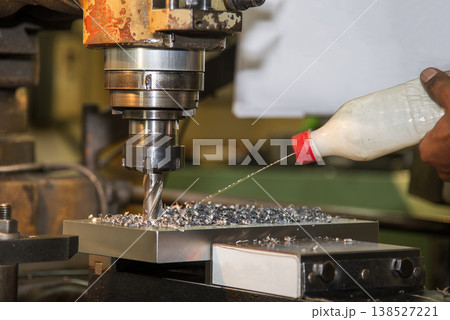 Heavy-duty plunge rough cutting on metal parts using a flat nose end mill and manual coolant application. Heavy-duty plunge rough cutting on metal parts using a flat nose end mill and manual coolant application. 138527221