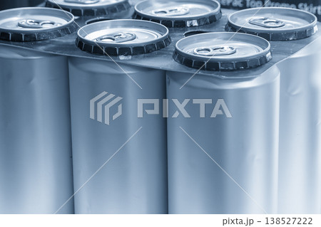 Multipack of aluminum drinking cans on a light blue background for beverage packaging and retail concepts. Multipack of aluminum drinking cans on a light blue background for beverage packaging and retail concepts. 138527222