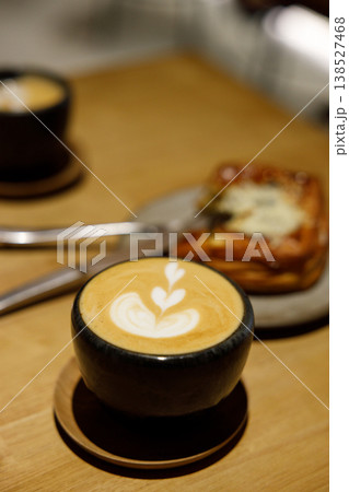 Cup of hot milk piccolo latte coffee on table. Cup of hot milk piccolo latte coffee on table. 138527468