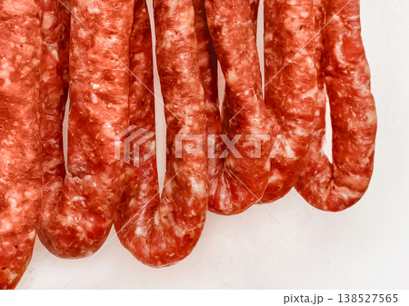 Drying sausages raw minced meat white wall background home Drying sausages raw minced meat white wall background home 138527565