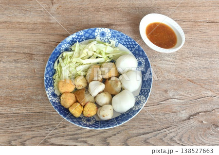 steamed fish and shrimp meatball with chop cabbage on plate dipping Thai spicy chili seafood sauce 138527663
