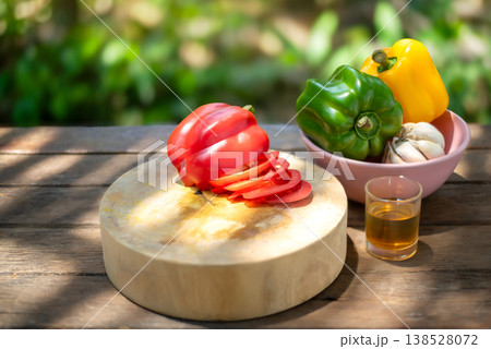 Fresh Sliced Red Bell Pepper on Wooden Board in Natural Garden Setting 138528072