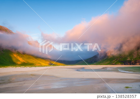 Norwegian arctic landscape with mountains, ocean, and blue sky. Norwegian arctic landscape with mountains, ocean, and blue sky. 138528357