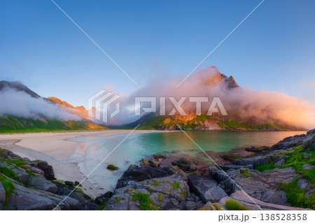 Lofoten Islands fjord at midnight sun. Norwegian arctic landscape with mountains, ocean and sky. 138528358