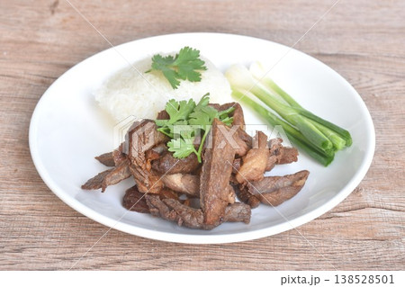 salty dry fried slice beef meat fermenting in sesame oil and pepper with sticky rice topping parsley on plate salty dry fried slice beef meat fermenting in sesame oil and pepper with sticky rice topping parsley on plate 138528501