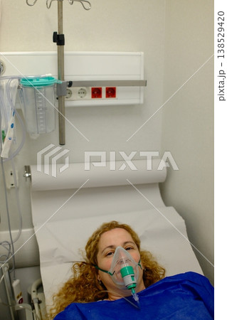 Woman on Hospital Stretcher with Oxygen Mask Woman on Hospital Stretcher with Oxygen Mask 138529420