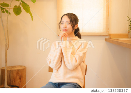 自宅で故人に祈りを捧げる娘 自宅で故人に祈りを捧げる娘 138530357