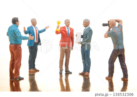 Five miniature figures engage in a discussion 138532306