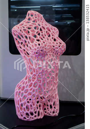 3D printed art object. Art object printed on 3D printer from melted colored plastic. Model in shape pink female body created on 3D printer from threads of molten plastic. Modern additive technologies 138532415