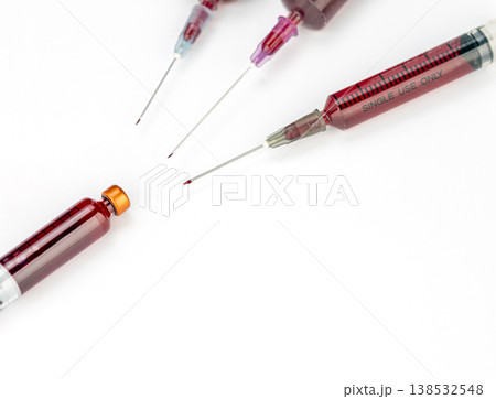 Close-Up of Multiple Medical Syringes Filled With Blood Alongside Glass Vials on a Clean White Background, Healthcare and Laboratory Concept Close-Up of Multiple Medical Syringes Filled With Blood Alongside Glass Vials on a Clean White Background, Healthcare and Laboratory Concept 138532548