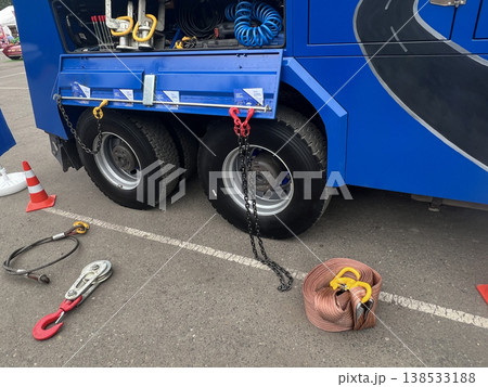 Heavy-duty vehicle maintenance in a parking lot with tools and equipment on display 138533188