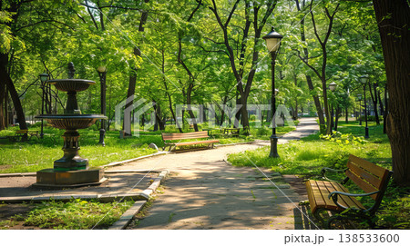 Tranquil City Park Scene with Fountain and Benches Amid Lush Greenery. Concept of Urban Oasis, Nature, Serene Retreat, and Outdoor Relaxation Tranquil City Park Scene with Fountain and Benches Amid Lush Greenery. Concept of Urban Oasis, Nature, Serene Retreat, and Outdoor Relaxation 138533600