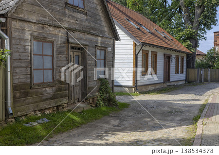 Strolling through the charming streets of Cesis Latvia with rustic wooden houses under a clear blue sky 138534378