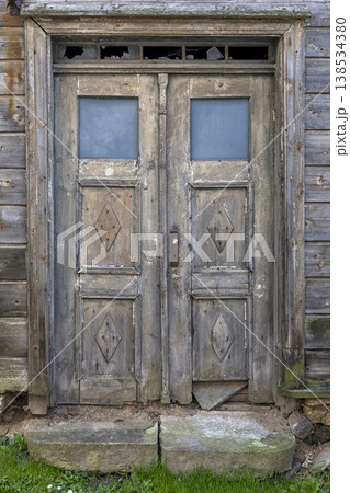Charming antique wooden door with diamond shapes inviting exploration in a rustic village Charming antique wooden door with diamond shapes inviting exploration in a rustic village 138534380