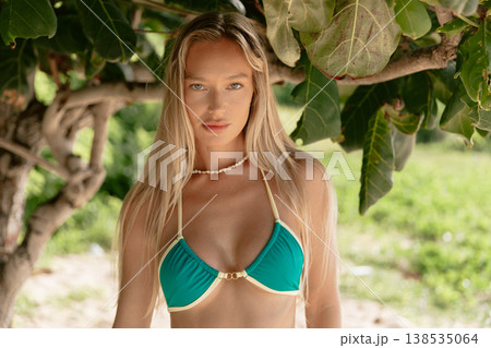Fashionable woman in bikini on tropical beach. Gorgeous model at ocean coast Fashionable woman in bikini on tropical beach. Gorgeous model at ocean coast 138535064