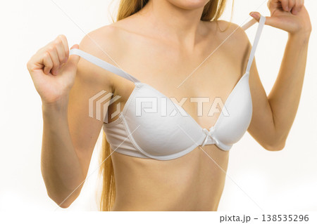 Young woman holding bra strap Young woman holding bra strap 138535296