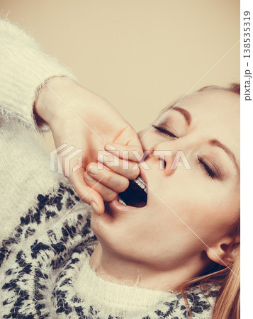 Sleepy yawning teenage woman in jumper 138535319