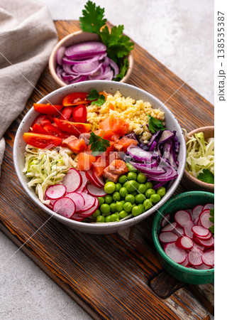 Balanced healthy bowl with vegetables and salmon 138535387