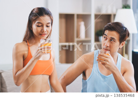 A happy couple prepares fresh vegetables, laughing and enjoying cooking a healthy meal together. A happy couple prepares fresh vegetables, laughing and enjoying cooking a healthy meal together. 138535468