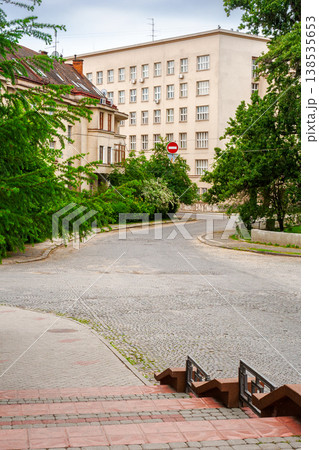 uzhhorod, ukraine - 03 jun 2012: urban scenery in summertime. view from hoidy street near park of st. tetyany with paved walkways. location near narodna square. cobbled street of uzhgorod city uzhhorod, ukraine - 03 jun 2012: urban scenery in summertime. view from hoidy street near park of st. tetyany with paved walkways. location near narodna square. cobbled street of uzhgorod city 138535653