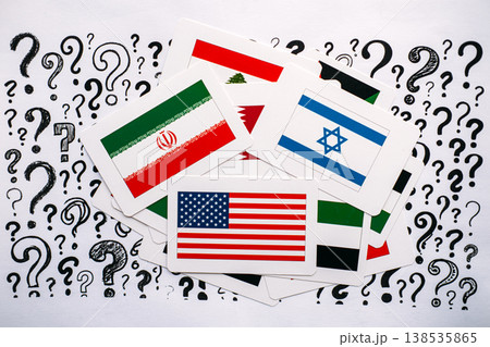 National flags of United States, Israel, Iran, and Lebanon lie scattered over paper with question marks. Global security uncertainty, future of international relations, complex political questions. National flags of United States, Israel, Iran, and Lebanon lie scattered over paper with question marks. Global security uncertainty, future of international relations, complex political questions. 138535865