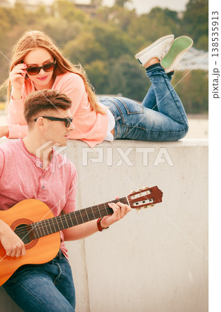 Happy couple with guitar outdoor Happy couple with guitar outdoor 138535913