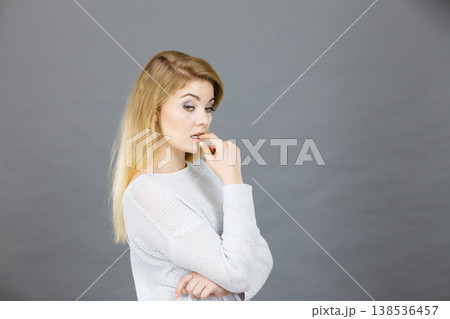 Blonde woman contemplating thinking about something Blonde woman contemplating thinking about something 138536457