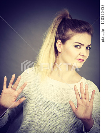 Woman deny something showing stop gesture with hands Woman deny something showing stop gesture with hands 138536458