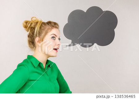 Woman holding black thinking bubble Woman holding black thinking bubble 138536465