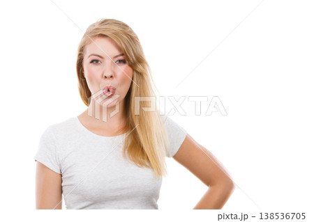 Funny blonde woman sitcking tongue out 138536705