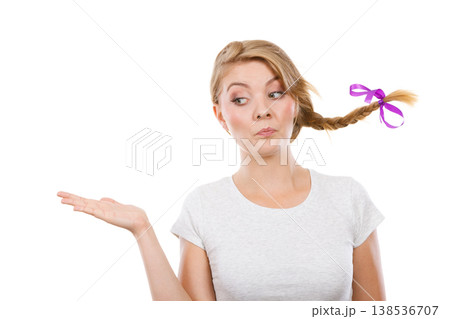 Happy teenage girl in braid hair presenting hand 138536707