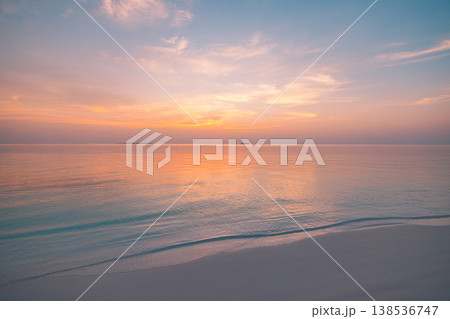 Tranquil sunset ocean surface with soft glowing horizon, inspirational summer seascape and colorful twilight sky Tranquil sunset ocean surface with soft glowing horizon, inspirational summer seascape and colorful twilight sky 138536747