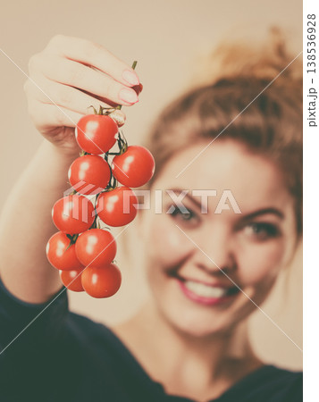 Woman holding fresh cherry tomatoes Woman holding fresh cherry tomatoes 138536928