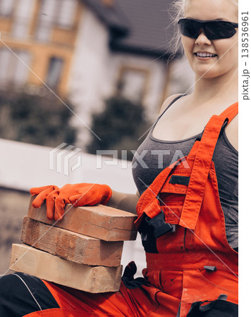 Strong woman building using bricks 138536961