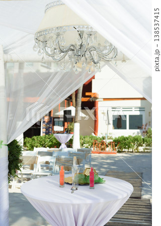 Crystal chandelier under white wedding canopy 138537415