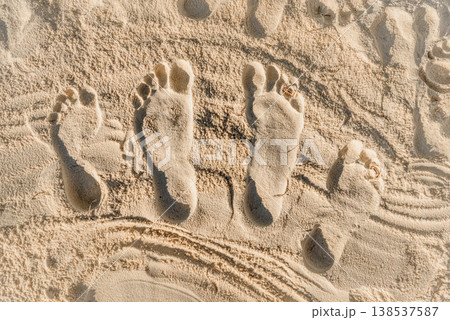 Family footprints with wedding rings in beach sand Family footprints with wedding rings in beach sand 138537587
