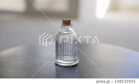 Small empty ribbed glass bottle with cork 138537935