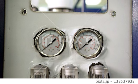 Industrial pressure gauges or manometers measuring bar and psi on a machine control panel 138537938