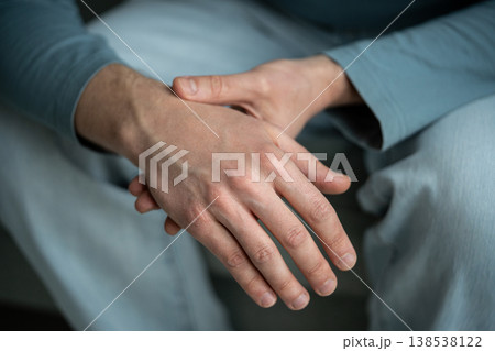 Closeup of man arms holding painful wrist. Carpal tunnel syndrome, arthritis. Numbness of hand 138538122