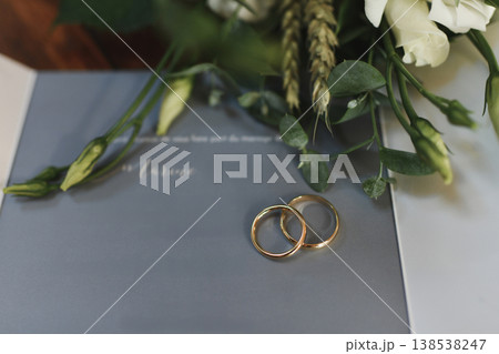 Wedding invitation with gold rings and flowers elegant 138538247