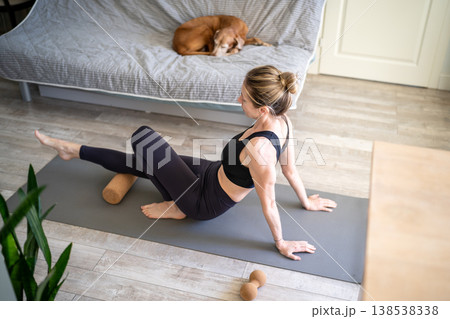 Athletic mature woman doing sports exercises for physical wellbeing at home, healthcare after 40-45. 138538338