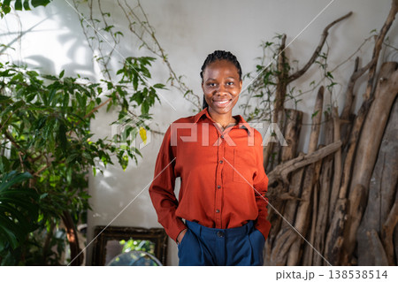 Positive confident African American woman posing in home garden with smiling optimistic expression. 138538514