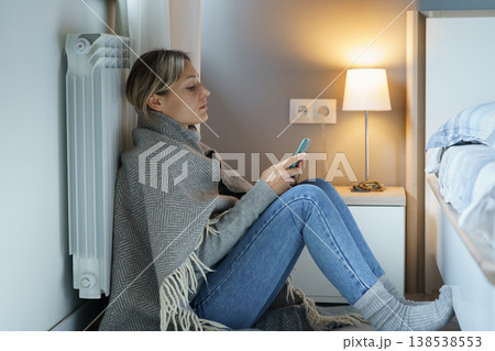 Tired blonde woman snuggling up to battery scrolls smartphone looking for vacancies via Internet Tired blonde woman snuggling up to battery scrolls smartphone looking for vacancies via Internet 138538553