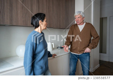 Enraged senior man yells at wife, tension erupt. Partners conflict, household stress in family  138538577