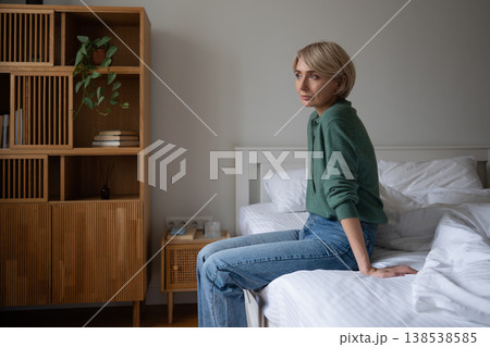 Thoughtful woman with blank expression staring at window engaged in deep thinking on life crisis. Thoughtful woman with blank expression staring at window engaged in deep thinking on life crisis. 138538585