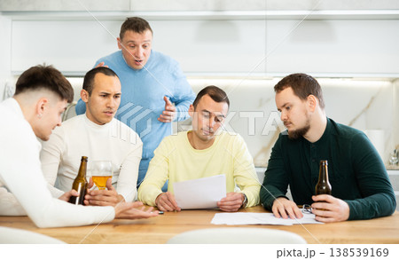 Friends comforting upset man receiving unpleasant news 138539169