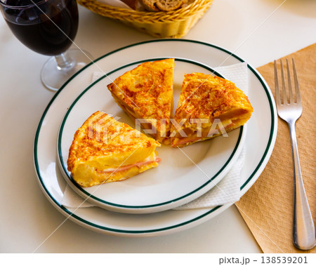 Pieces of tortilla with jamon 138539201