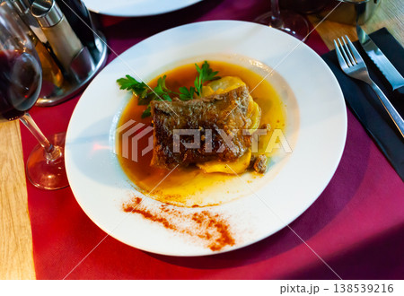 Braised pork meat in sauce with baked potato 138539216