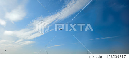 Passenger airplane taking off and climbing into a vast blue sky, leaving a contrail trail behind, symbolizing aviation, travel, and the journey of flight. 138539217